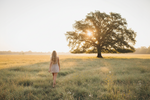 Woman walking confidently through a peaceful meadow, symbolizing rediscovering herself, rebuilding identity, and finding self-trust after a toxic relationship.